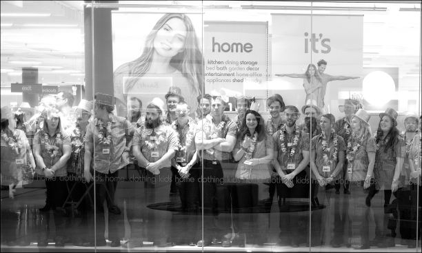 Shop assistants in the window looking out at shoppers