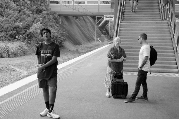 Young lad looking at the notice board at a railway station