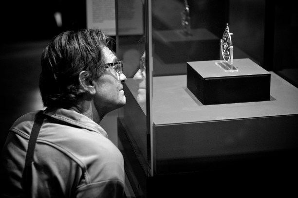 Close up of a man looking at an object in a protective case