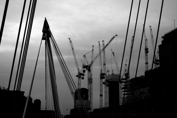 Photo of cranes against a cloudy sky