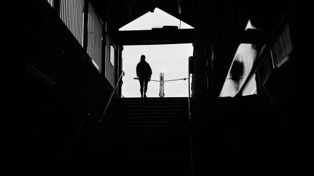Silhouette of person coming from a swet of steps